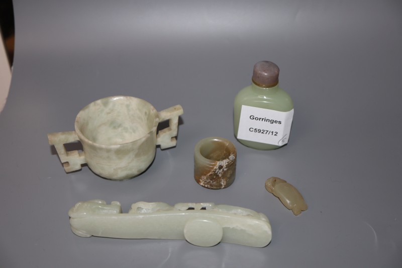 A Chinese jade belt hook, an archers ring and figure, a stone cup and a glass snuff bottle